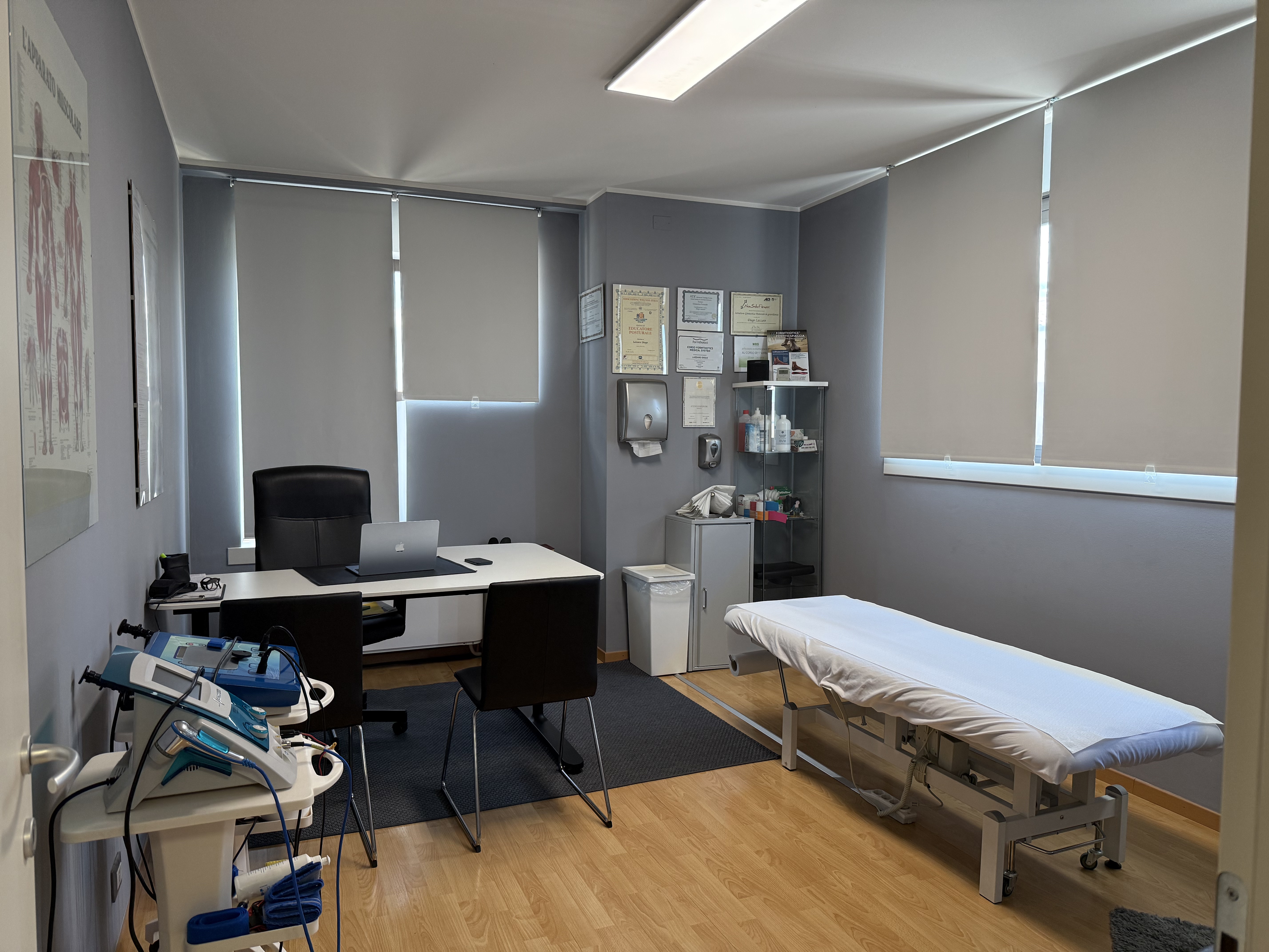 Interno dello studio professionale di Diego Lazzaro con lettino, scrivania e attrezzature mediche